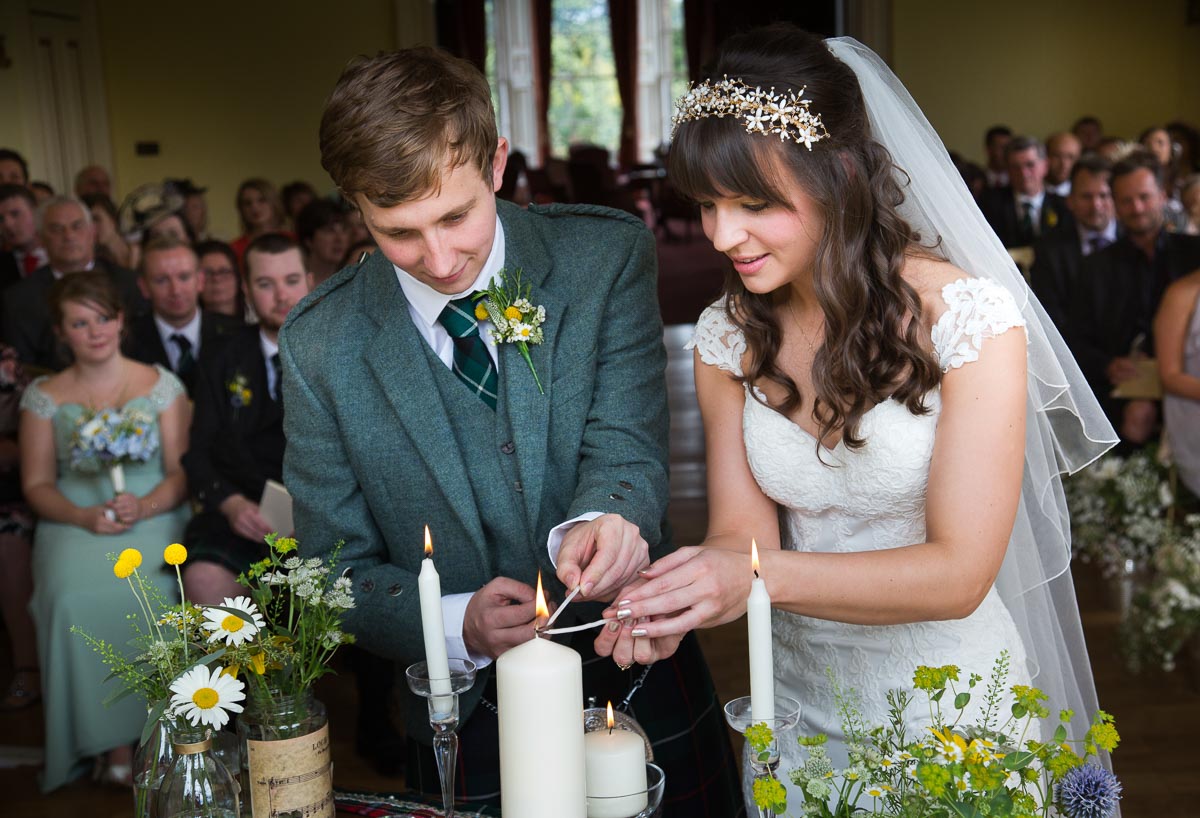 Wedding couple lighting candle together